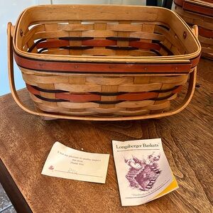 Longaberger Basket. Red & blue trim. 10.5 by 7.5 w/ handle. Paperwork included.